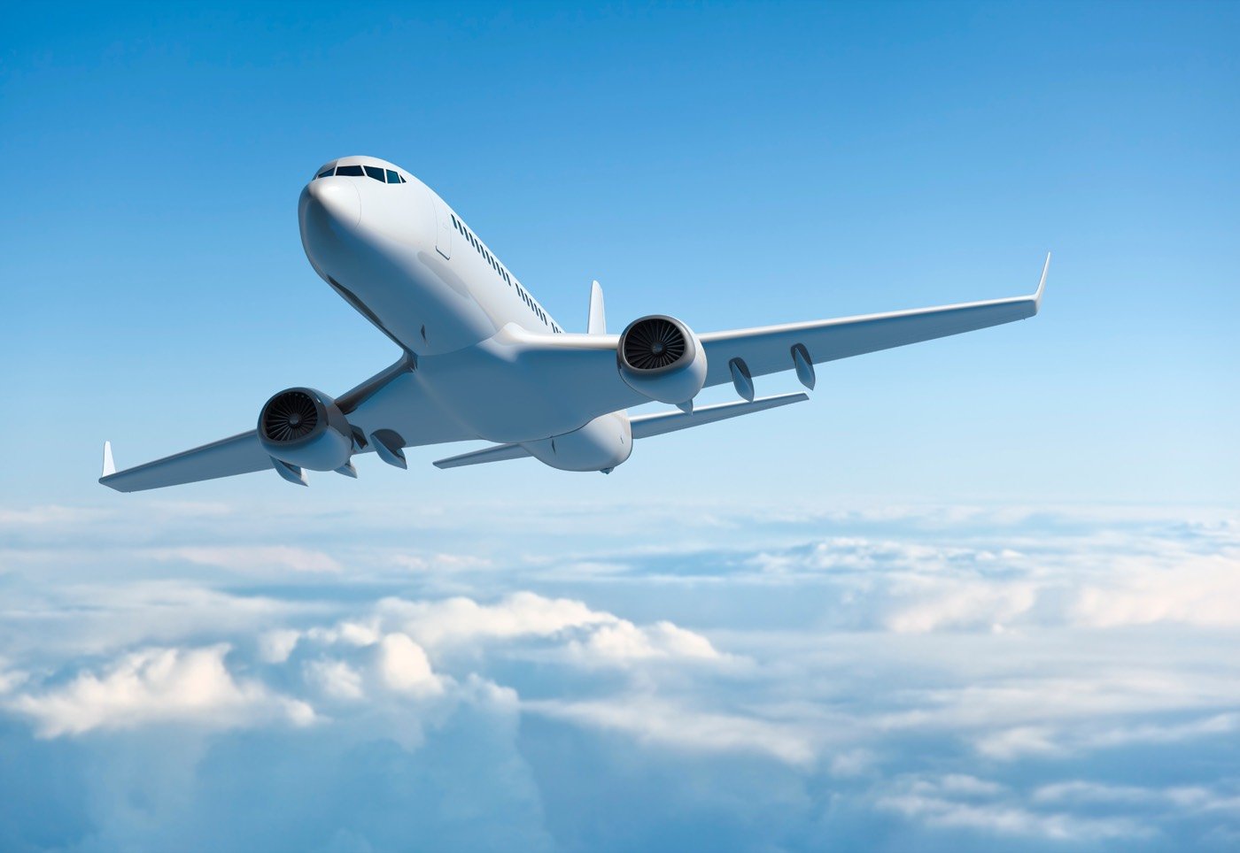 Commercial jet in flight above the clouds